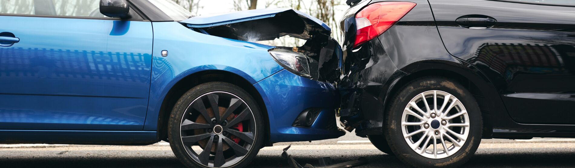 Blue and black cars after a collision