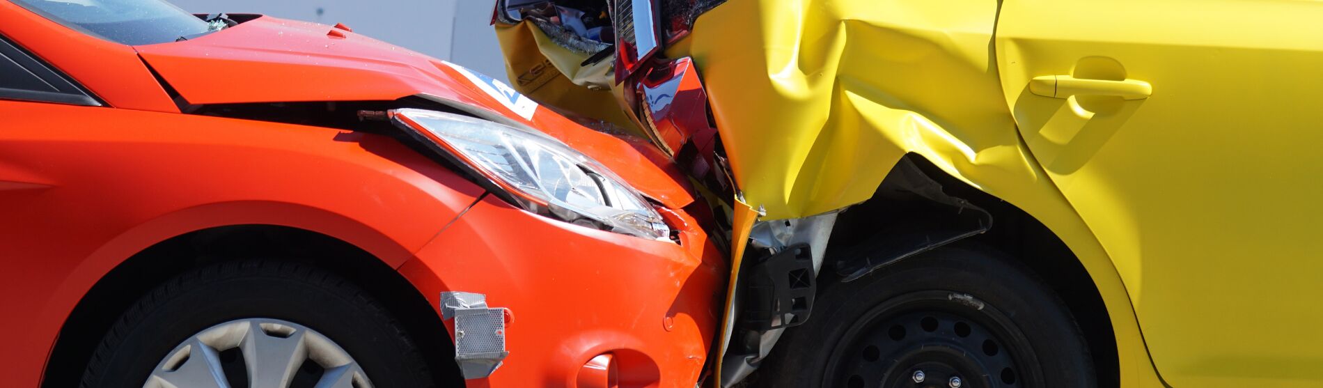Orange and yellow cars after a collision