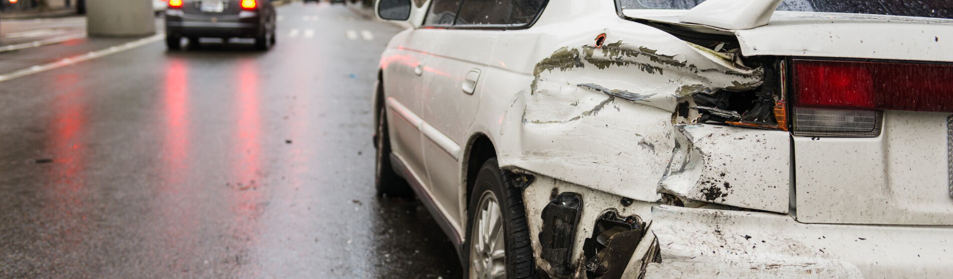 White car with rear-end collision damage